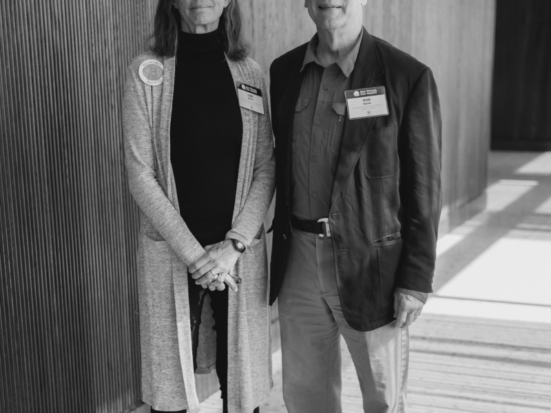A black and white photo of Lori and Robert Byron standing in a sunlit building interior